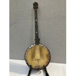 An early 20th Century five string banjo, closed back, damage to skin, some lifting to back, with