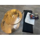 A pair of Zildjian ZBT hi hat cymbals together with sticks and associated fittings