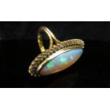An opal and diamond ring the central oval opal 26.9mm x 10.4mm x 5.4mm, estimated weight 8.87ct