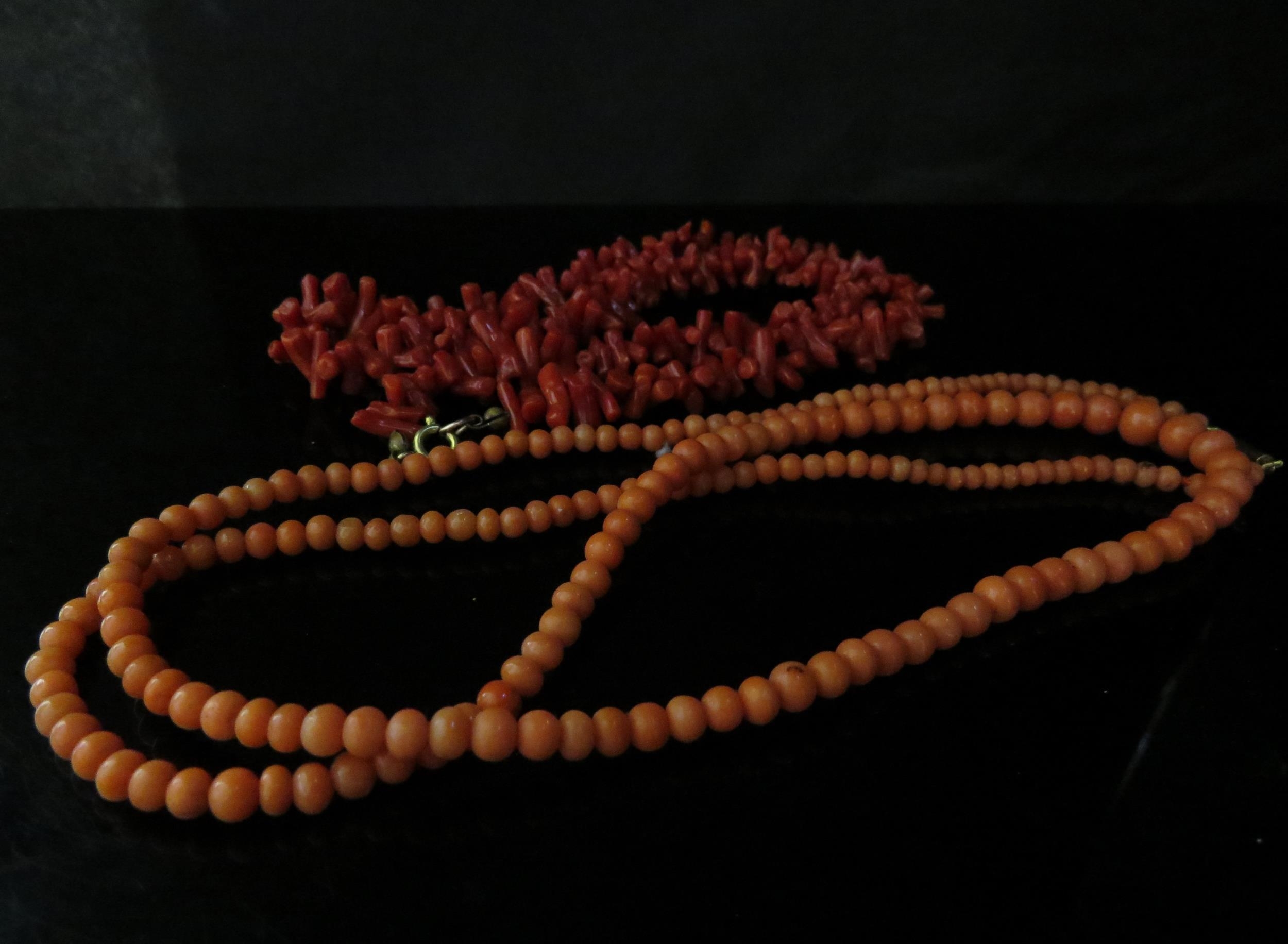 A coral bead necklace with clasp stamped 9ct, 72cm long and a branch coral necklace, 47cm long