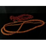 A coral bead necklace with clasp stamped 9ct, 72cm long and a branch coral necklace, 47cm long