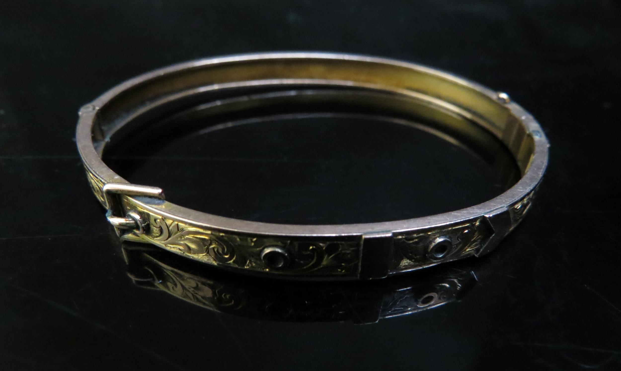 A 9ct gold engraved buckle bangle, 7.1g