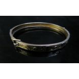 A 9ct gold engraved buckle bangle, 7.1g