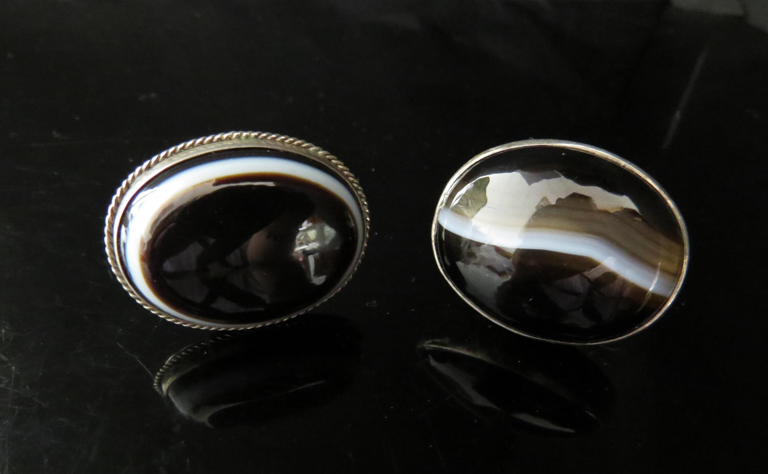 Two large banded agate rings including silver marked example. Sizes N and J, 32g