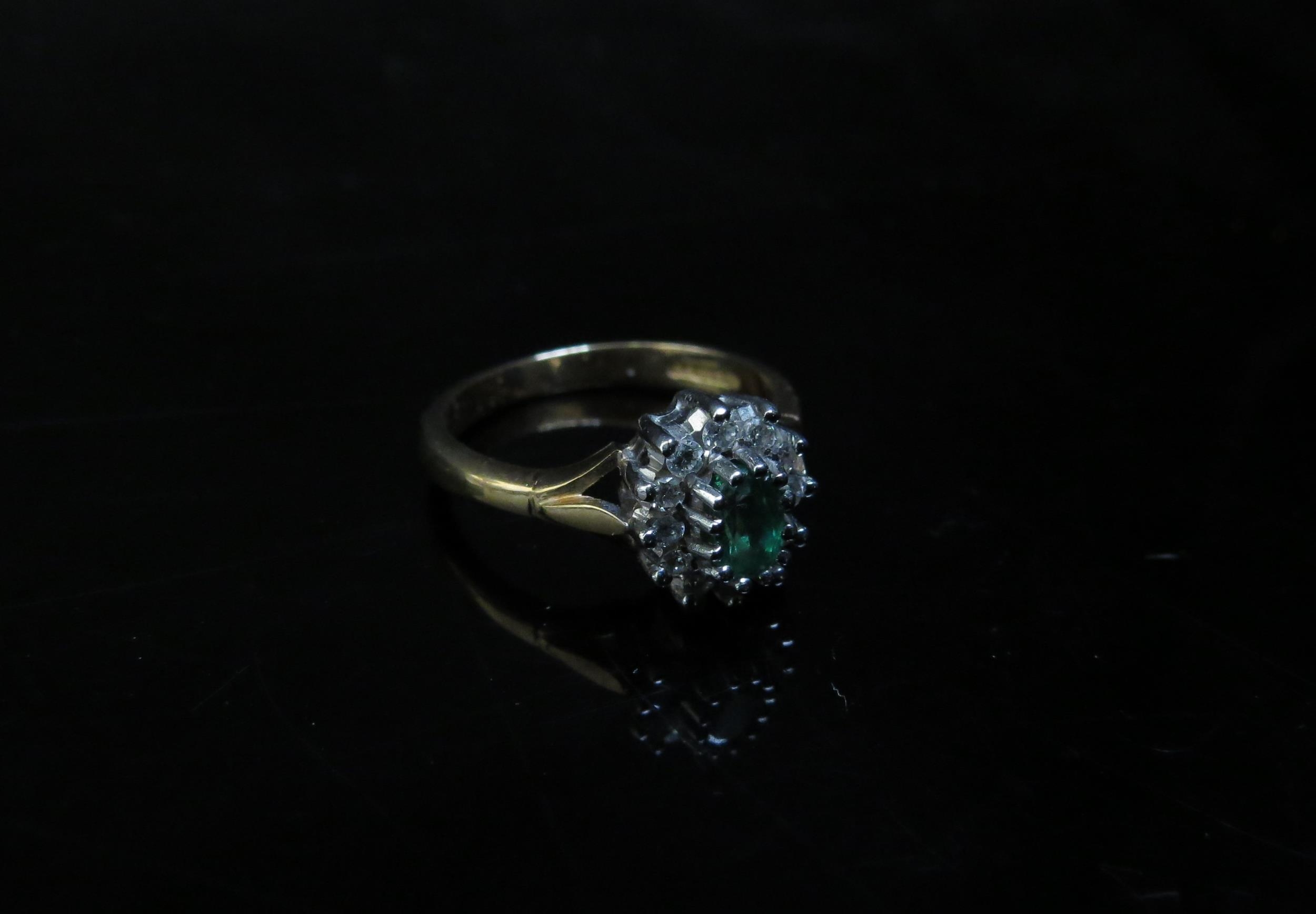 A 9ct gold emerald and diamond cluster ring. Size M, 3.1g