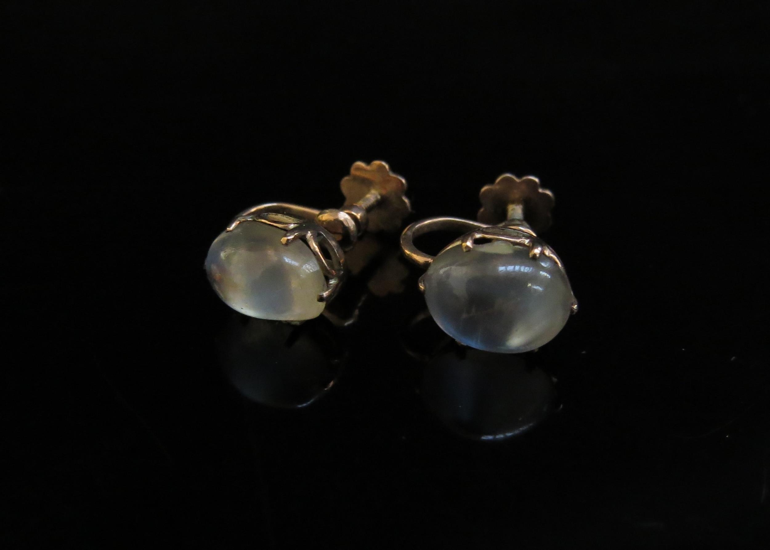A pair of cabochon moonstone earrings, unmarked gold, 2.3g