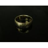 A 9ct gold textured band. Size R, 6g