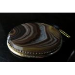 A large banded agate oval brooch in ornate unmarked frame, 6cm x 5cm