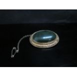 A Victorian green moss agate oval brooch in ornate unmarked gold frame, 4.3cm x 3.4cm