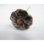 A Liberty & Co Cymric silver hatpin of flower form with coral centre