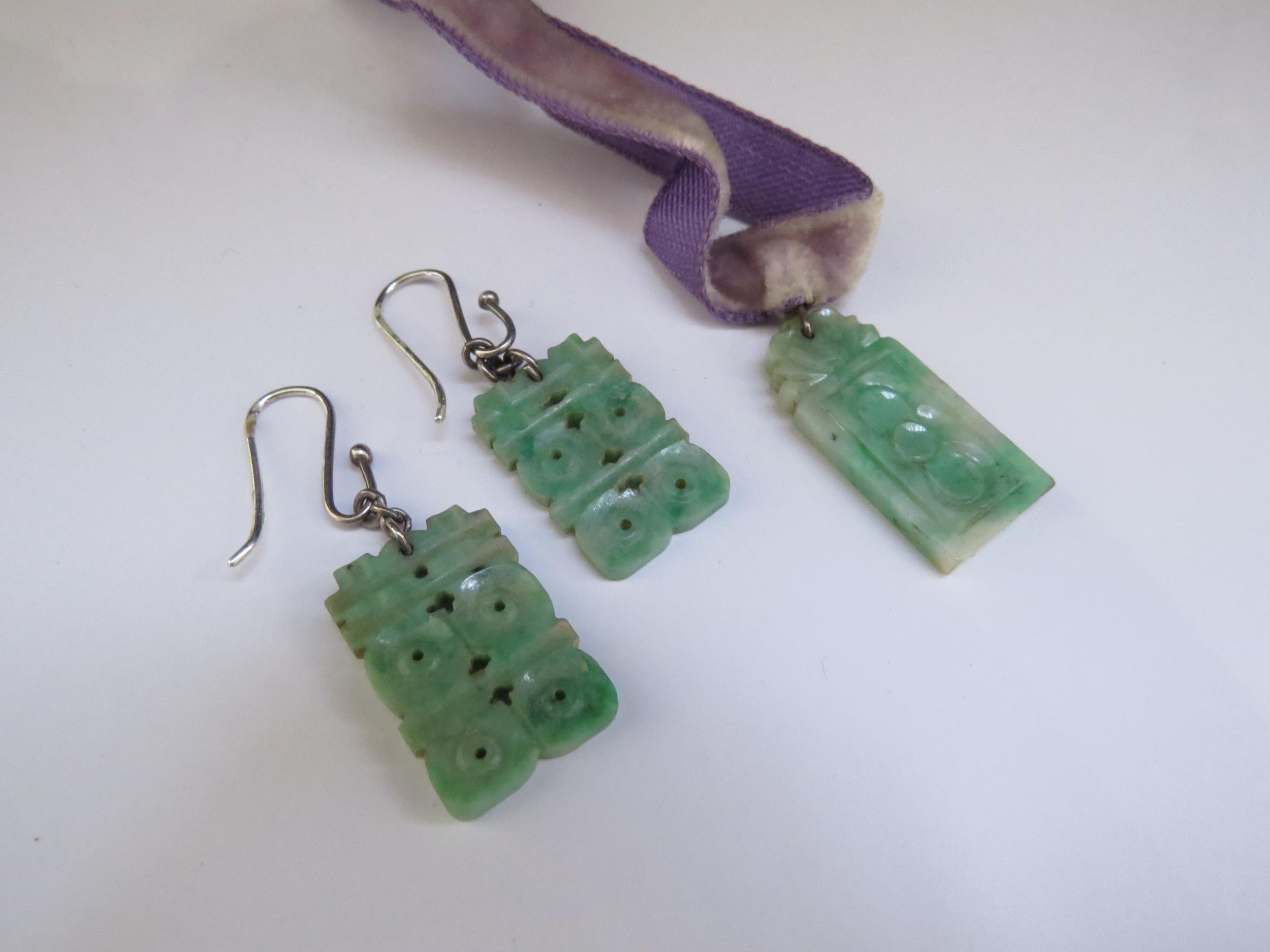 A pair of carved jade drop earrings and similar pendant (3)