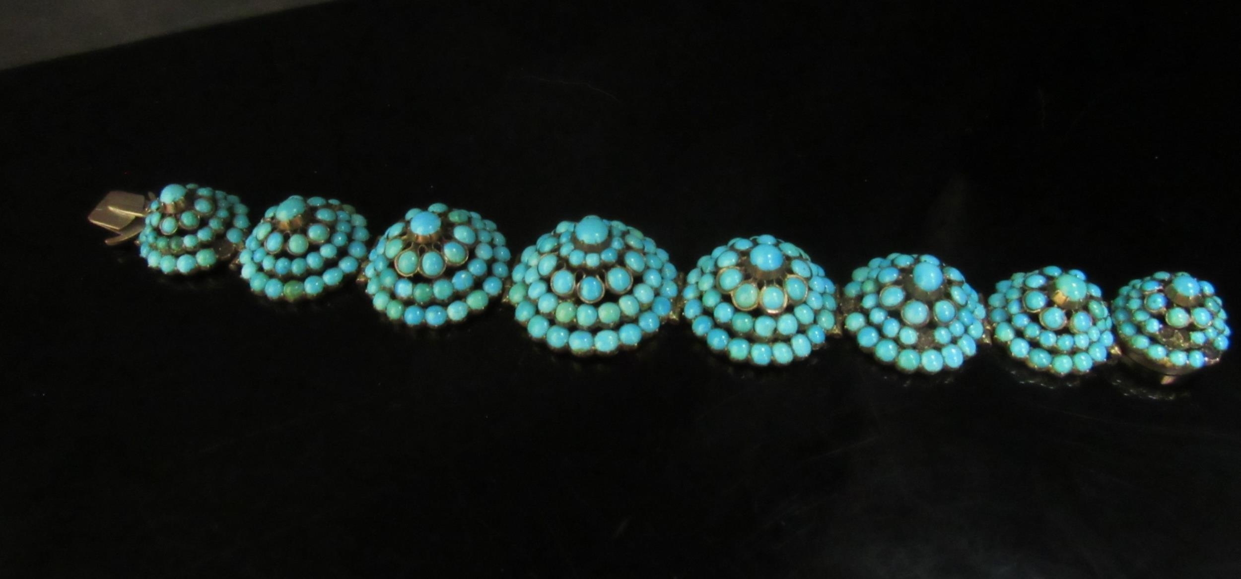 An eight panel turquoise cluster dome top bracelet, some stones missing, 18cm long