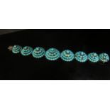 An eight panel turquoise cluster dome top bracelet, some stones missing, 18cm long