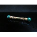 A Victorian gold bar brooch with grape and vine decoration, the terminals as malachite spheres,