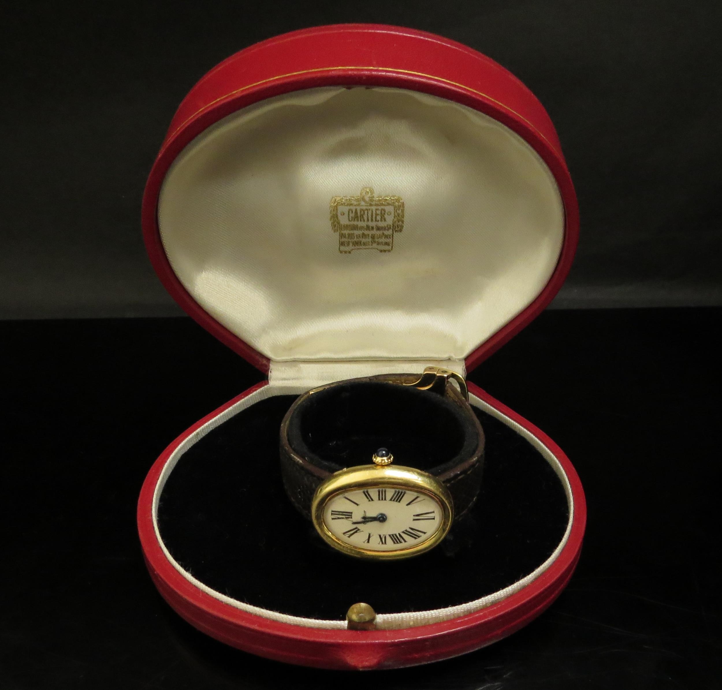 A Cartier "Baignoire" lady's wristwatch, 18ct gold case, Roman numerated oval dial with a sapphire