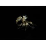 An 18ct gold textured bow brooch with three rows of diamonds, 10.2g