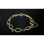 A 9ct gold bracelet with textured links, 18cm long, 10.2g
