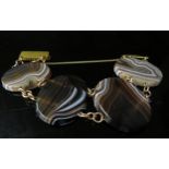 An oval four panel banded agate bracelet with replacement gilt clasp