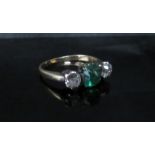 A yellow gold emerald and diamond ring the central cabochon cut emerald 6mm diameter, 5mm deep