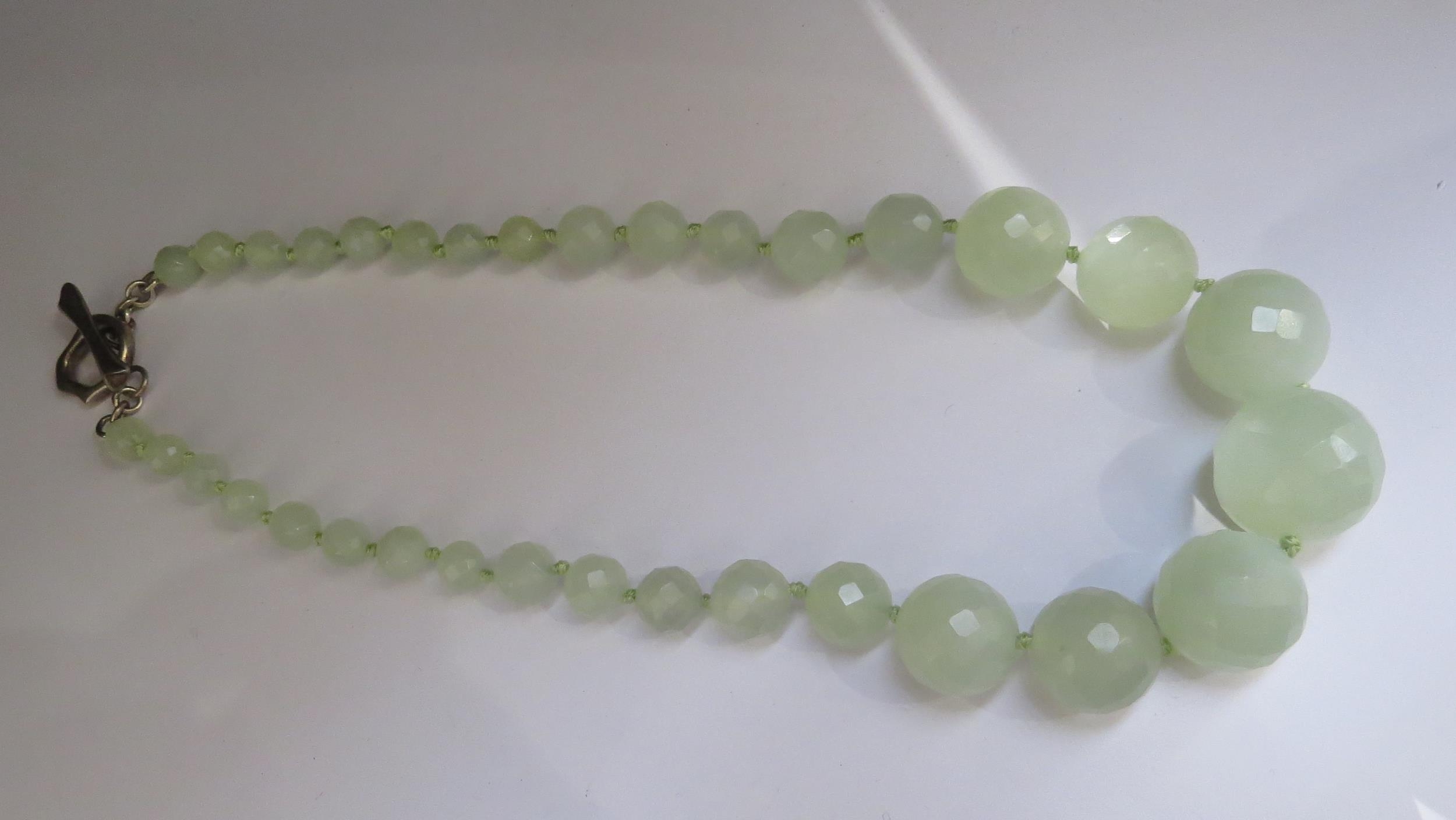 A pale green facet cut graduated bead necklace, 45cm long