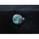 A Georgian emerald and diamond ring, the central emerald 10mm x 10mm framed by thirteen old cut
