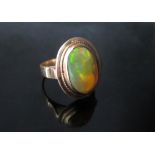 A gold ring set with an oval cabochon yellow opal (shank replaced) unmarked. Size O, 3.6g