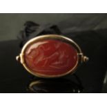 A Victorian unmarked gold swivel fob/pendant depicting a carved intaglio in cornelian of Leda and