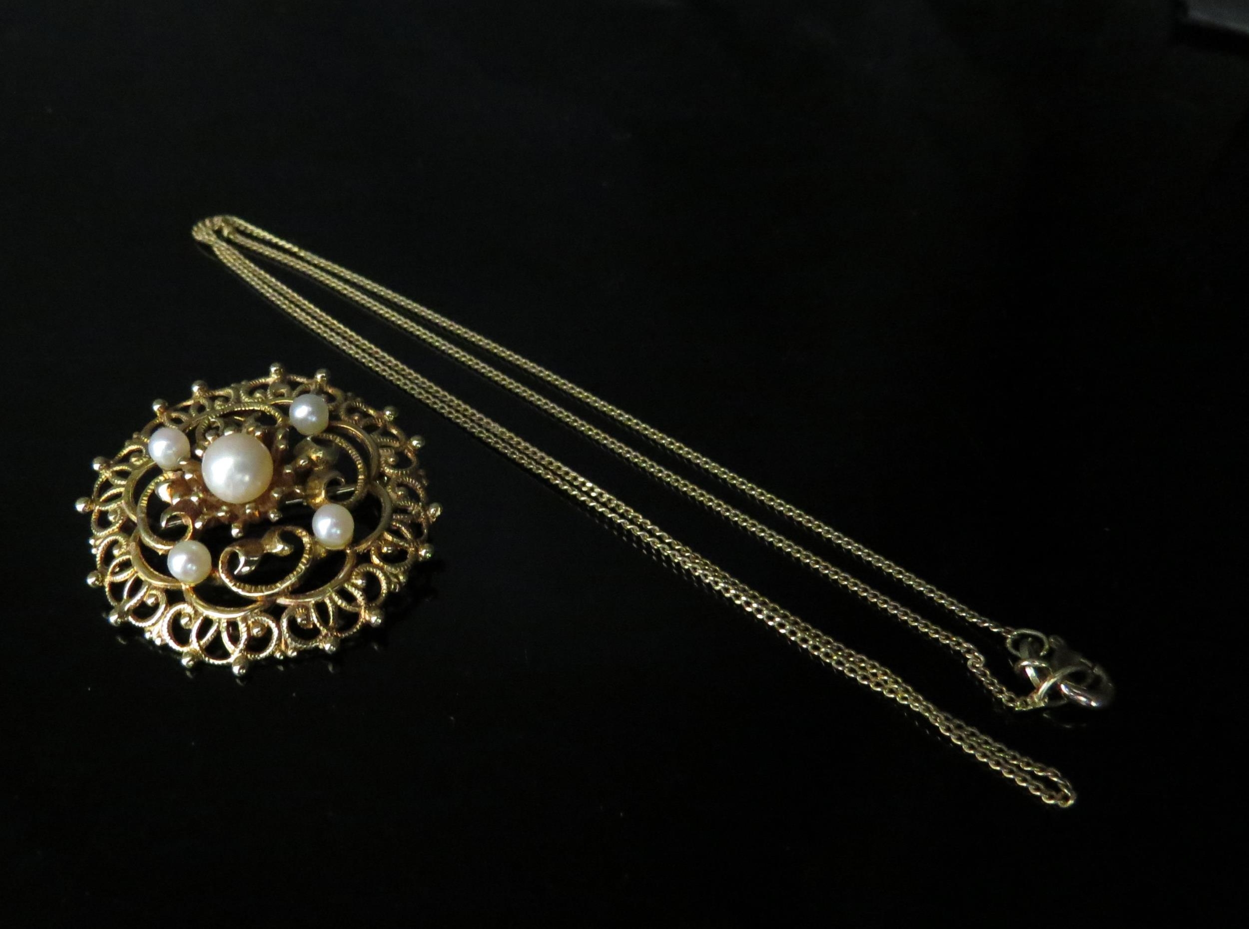 A gold neckchain stamped 585 and a gold and pearl brooch stamped 585, 7.5g