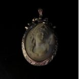 A Victorian carved lava cameo pendant with high relief of a maiden, ornate gold frame stamped 9ct,