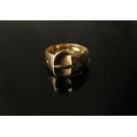 An 18ct gold buckle ring set with two diamonds in rubover star settings. Size O, 7.4g