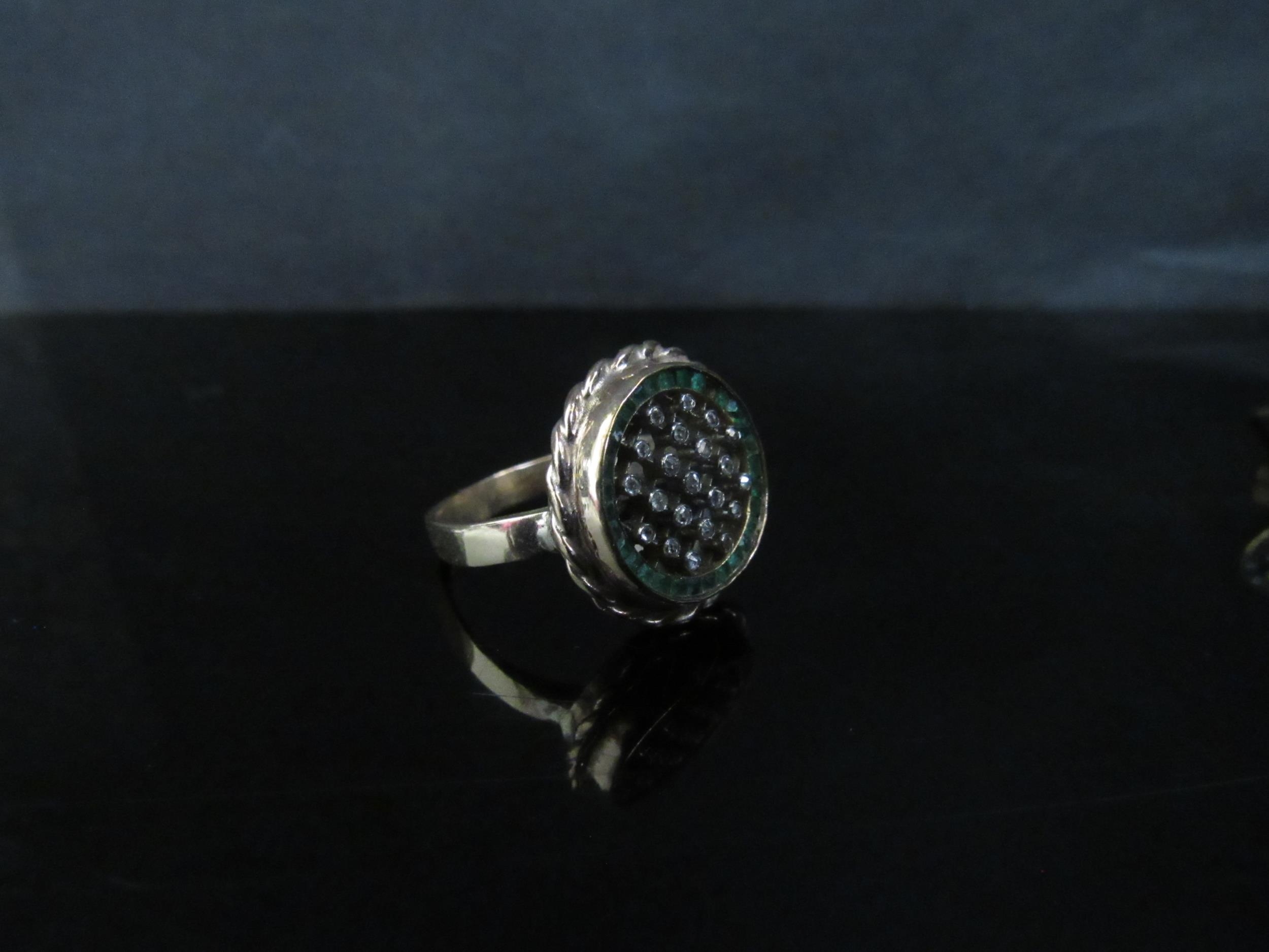 A 9ct gold ring with a circular crosshatch design studded with small diamonds framed by square cut - Image 2 of 3