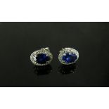 A pair of 9ct white gold sapphire and white stone cluster earrings, 1.4g