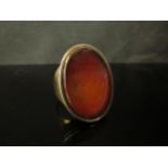 A Victorian gold ring with large Cornelian carved intaglio of a shield, unmarked. Size S, 13.1g