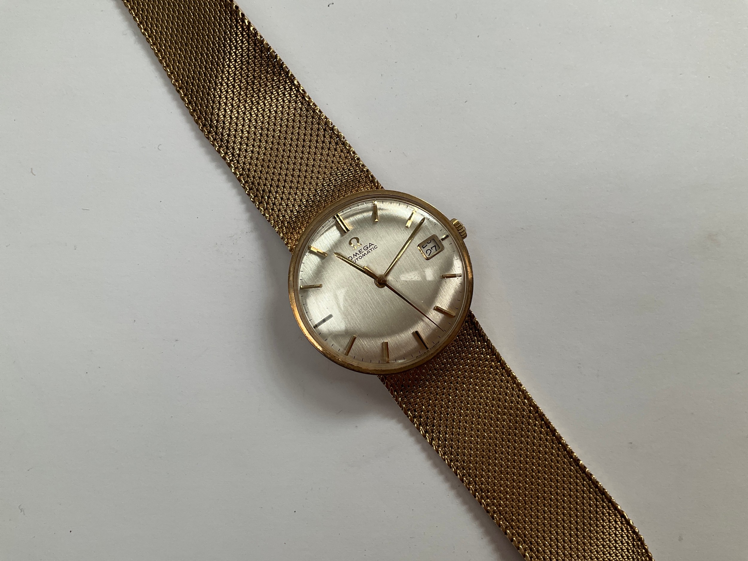 A 9ct gold Omega automatic gentleman’s wristwatch, case and strap stamped 375, with documentation