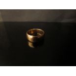 An 18ct gold wedding band, 7mm wide. Size R/S, 8.4g