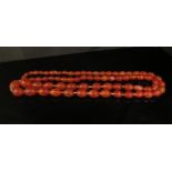 A cornelian graduated oval bead necklace, 100cm long