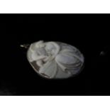 A Victorian shell carved cameo pendant depicting Hebe feeding the Eagle, 4.5cm long in white metal