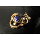 A gold enamelled foliate scroll brooch, enamel a/f, with two pearls, stamped 18k, 12.5g