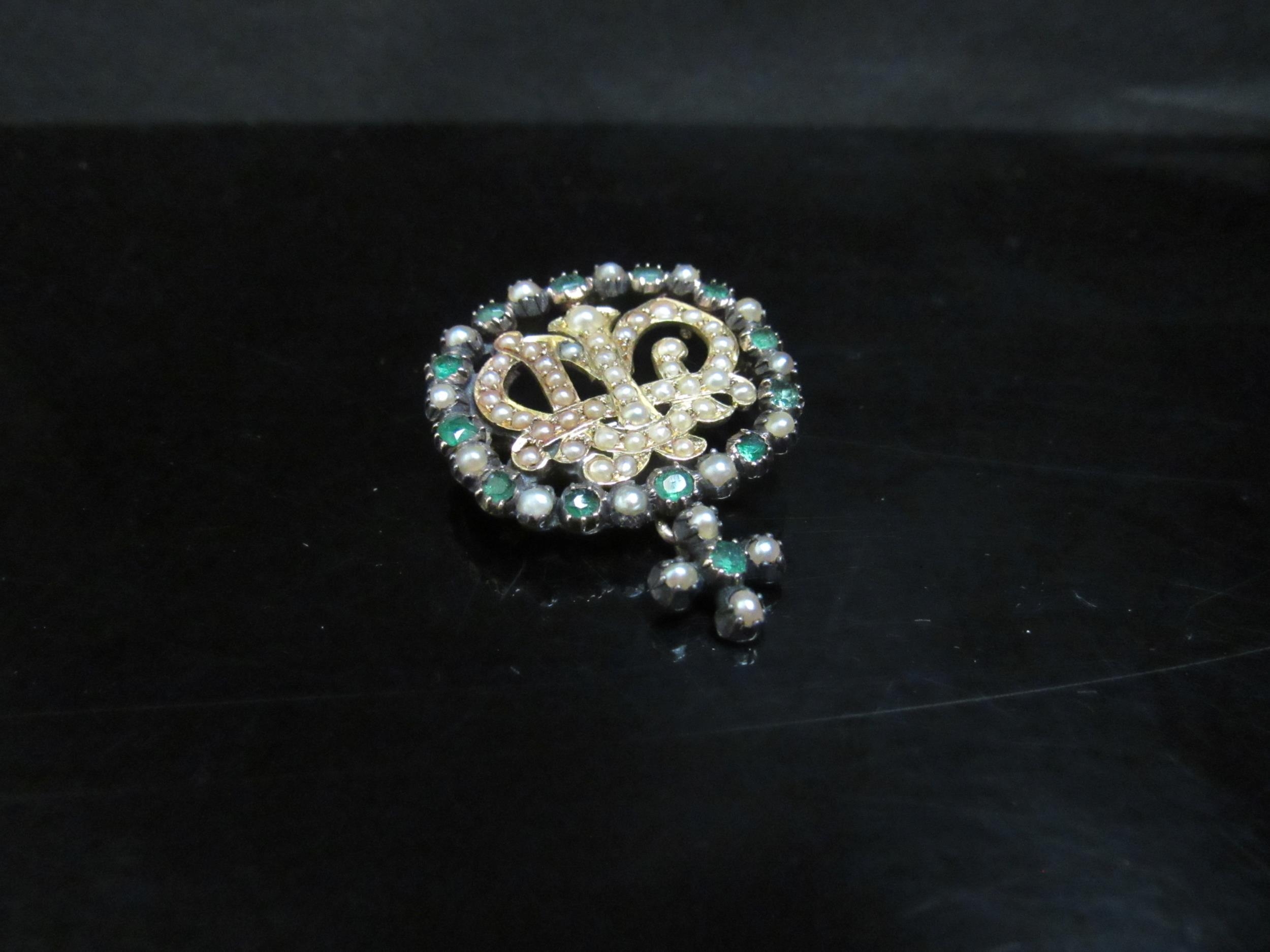 An emerald, seed pearl set brooch converted from a buckle, crown monogram to centre, unmarked, 7.3g