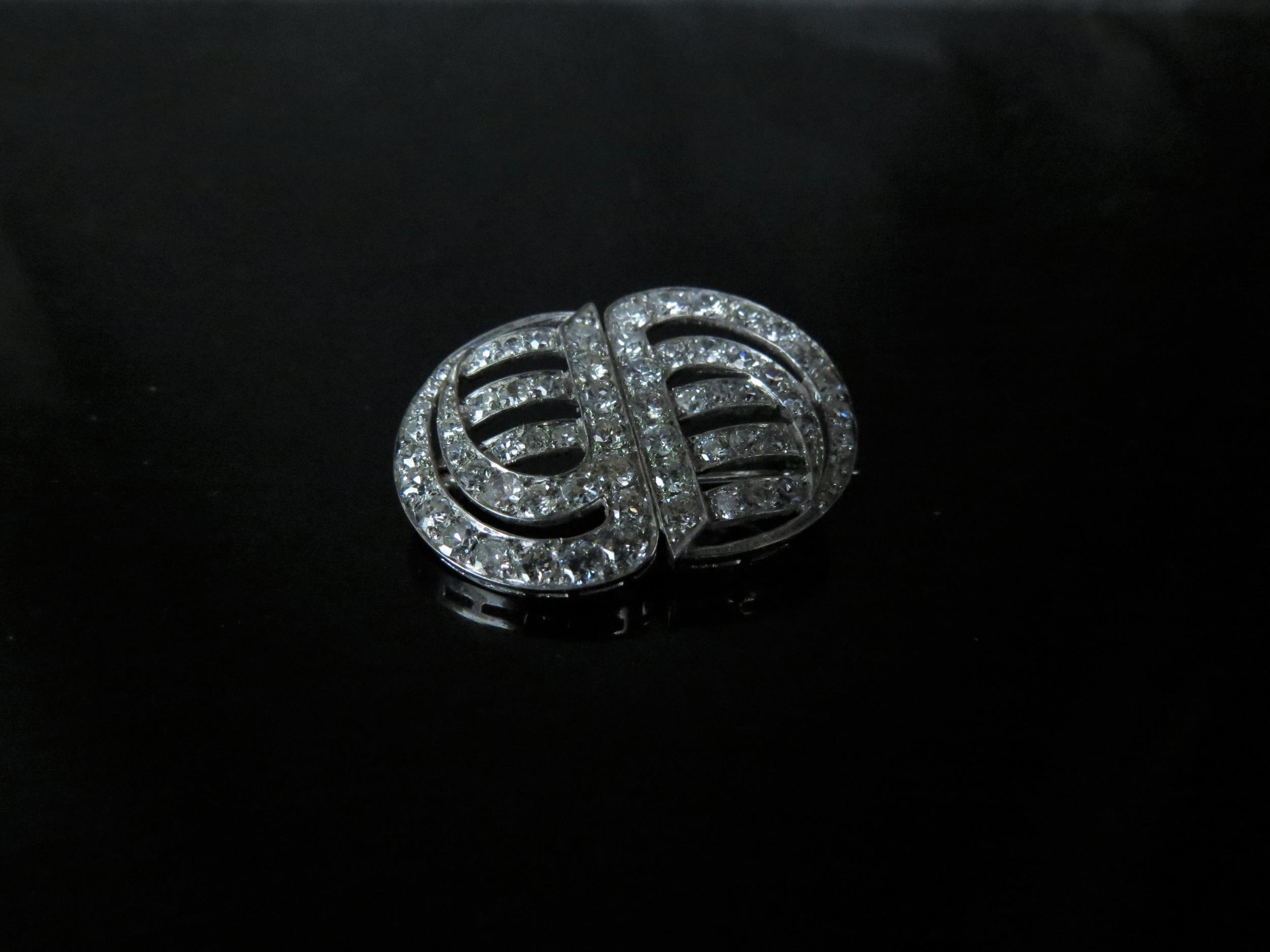 An Art Deco diamond encrusted brooch, formally a pair of clips, unmarked platinum, 2.5cm x 1.9cm, 5g