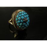 A gold ring with removable domed turquoise front centrally set with a small diamond in star
