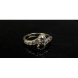 A gold diamond and sapphire cross-over ring with diamond set shoulders, stamped 18ct (rubbed).