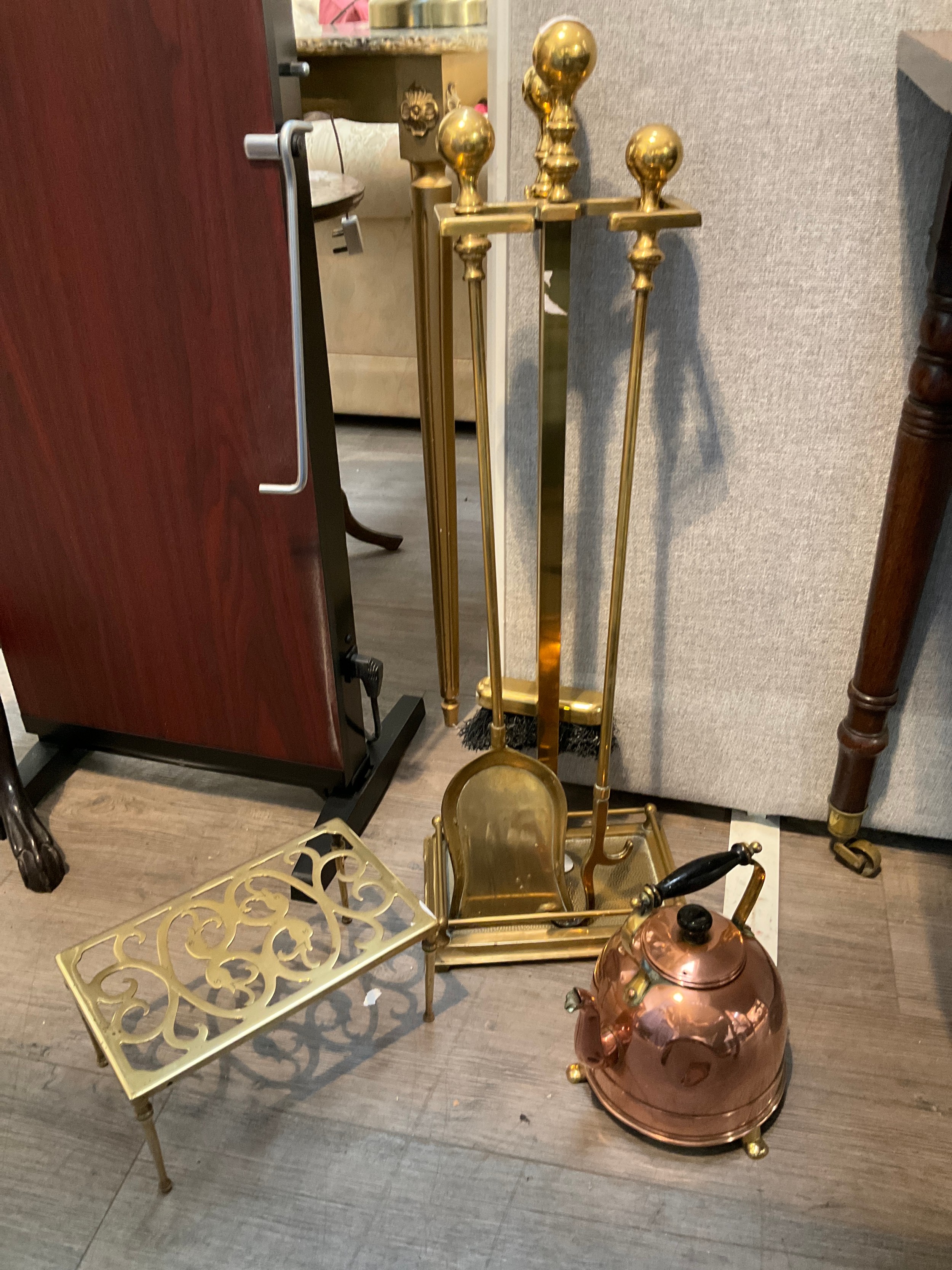 A brass companion set with stand, brass trivet and copper kettle (dented)