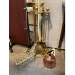 A brass companion set with stand, brass trivet and copper kettle (dented)