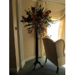 A mahogany melon fluted torchere stand with faux floral display