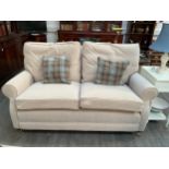 A modern beige two seater sofa with feather filled cushions, fire labels to cushions approx 167 long