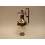 A Victorian Robert & Belk silver claret jug, the lid surmounted by helmet, the body engraved with