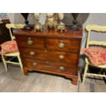 A Regency mahogany chest of two over two drawers with oval plate embossed thistle handles, reeded