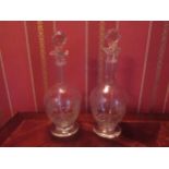 A pair of Edwardian crystal etched glass decanters