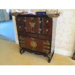 A 20th Century Chinese Oriental cabinet with drawers and cupboards, central section with two